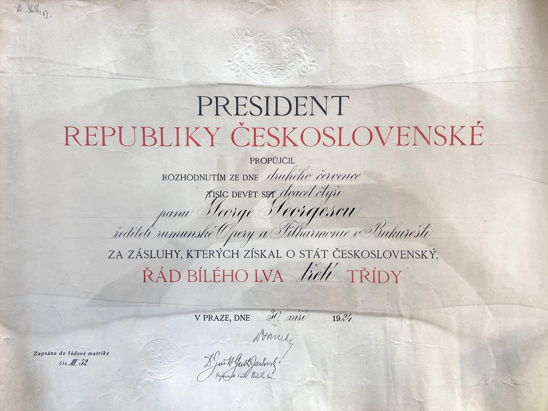 Stříbrná řádová hvězda a osmicípý klenot Československého řádu Bílého lva položené v otevřené etuji